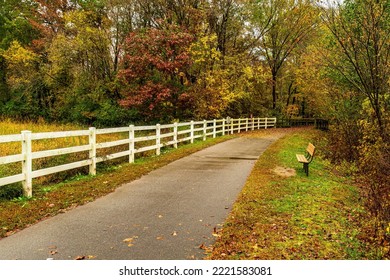 Raleigh, North Carolina USA-11 01 2022: A Quiet Bench On The Neuse River Trail In Autumn.