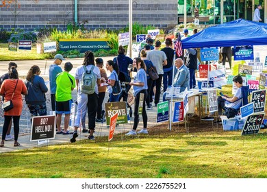 Raleigh, North Carolina USA-11 05 2022: Women Hand Out Information About Democratic Candidates While People Stand In Line To Vote In The 2022 Midterm Election.