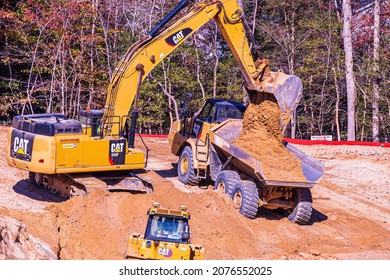 Raleigh, North Carolina USA-11 17 2021: A Power Shovel Fills A Dump Truck With Dirt To Clear Land For Home Construction.