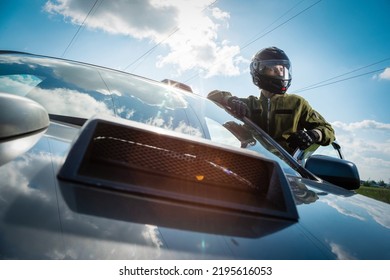 Rally car driver standing near the racing car concept. - Shutterstock ID 2195616053