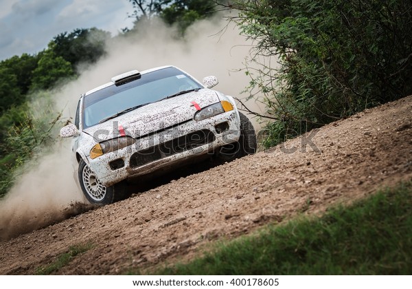 Rally car on dirt\
track