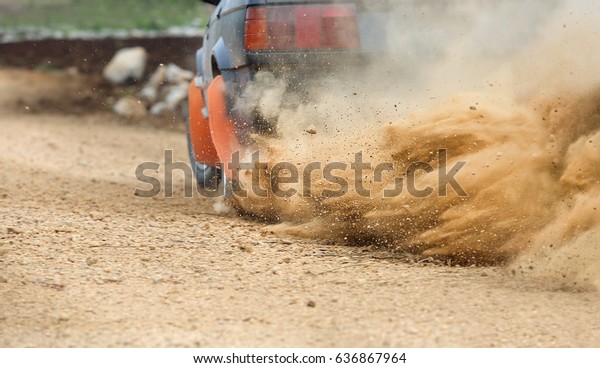 Rally Car turning in dirt\
track