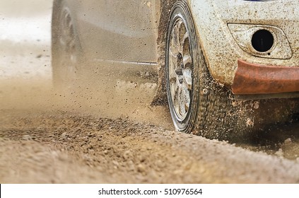 Rally racing car increase speed in muddy road - Powered by Shutterstock