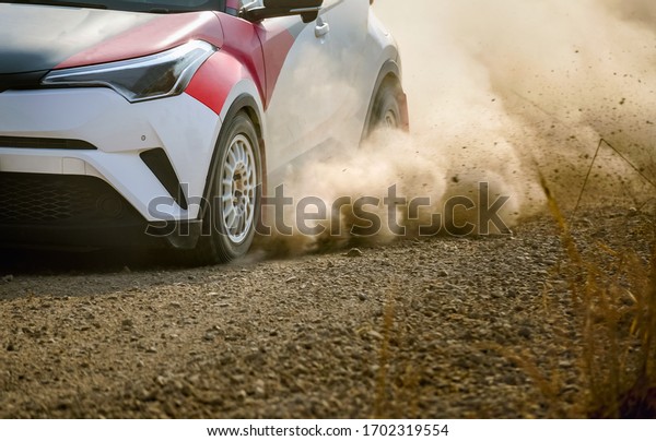 Rally racing car on dirt\
road.