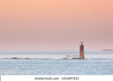 Ram Island Ledge Lighthouse at sunset, Portland Maine. The light is a lighthouse in Casco Bay, Maine, United States, marking the northern end of the main channel leading the harbor of Portland, Maine.