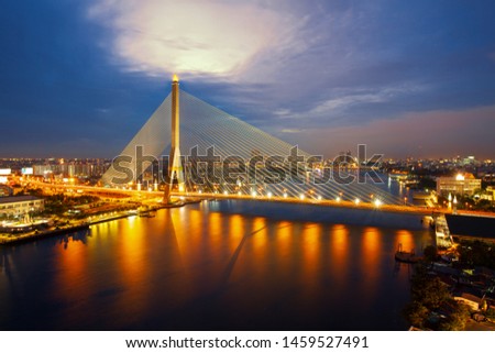 Rama VIII bridge in Bangkok at twilight. Thailand beautiful bridge across the Chao Phraya river with fantastic sky.