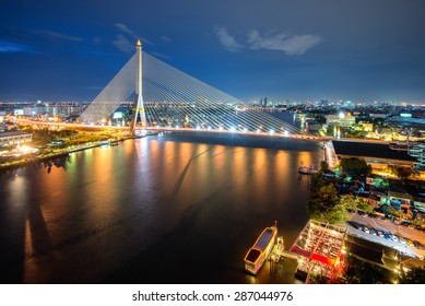 Rama VIII Bridge at night in Bangkok and Chopraya river, Thailand