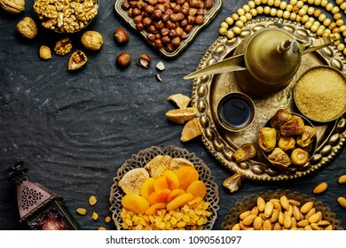 Ramadan Concept. Varieties Of Dried Fruits, Nuts, Arabian Coffee,dates And Traditional Ramadan Lantern On Rustic Dark Background. Top View With Copy Space.