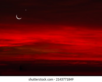 Ramadan, Eid ai-fitr,New year Muharram islamic religion Symbols with Crescent Moon and star silhouette on dark red and dark black twilight sky in night sunset. copy space for add text presentation. - Shutterstock ID 2143771849