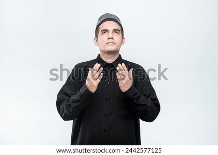 Ramadan, EIDMUBARAK, Asian Muslim men are praying with faithful faces and following Islamic practices, on white background, with copy space.