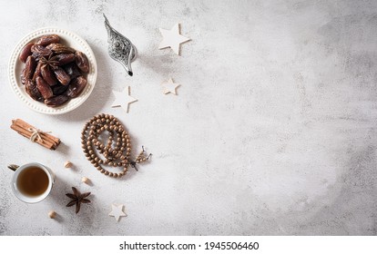 Ramadan Food And Drinks Concept. Ramadan Arabian Lamp, Wood Rosary, Tea, And Dates Fruit On Dark Stone Background.