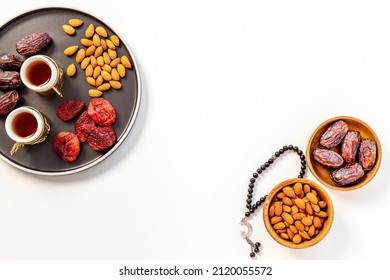 Ramadan holyday table with dates fruits and islamic rosary with star and crescent - Shutterstock ID 2120055572