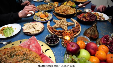 Ramadan Iftar Eid. Muslim Family Has Dinner At Home. Table With Traditional Food. Eid Al-Fitr Celebrations