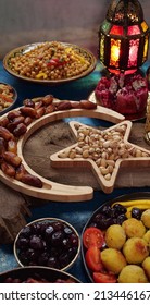 Ramadan Kareem With Dates, Nuts And Sweets Arranged In Shape Of Islamic Crescent Moon And Star. Iftar Food Concept, Holiday Table