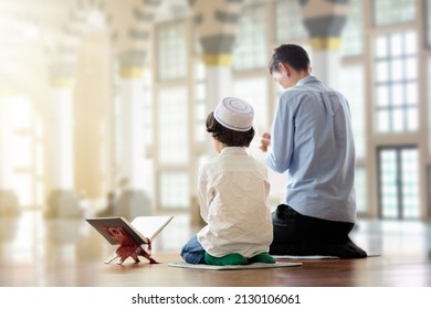 Ramadan Kareem greeting. Father and son in mosque. Muslim family praying. Man and child read Quran and pray. End of fasting. Hari Raya day. Eid al-Fitr celebration. Breaking of holy fast day.  - Shutterstock ID 2130106061