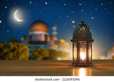 Ramadan Kareem greeting. Islamic lantern on night sky with crescent moon and stars. End of fasting. Hari Raya card. Eid al-Fitr decoration. Breaking of holy fast day. Muslim holiday. - Shutterstock ID 2126591096
