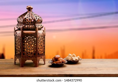 Ramadan Kareem greeting photo with serene mosque background with beautiful glowing lantern. 
    
    - Image