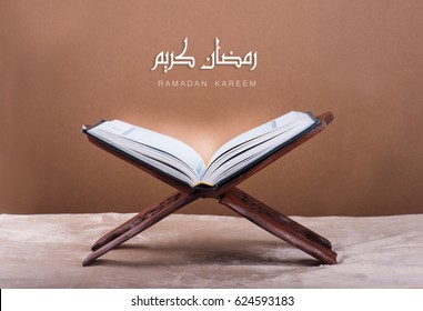 Ramadan kareem with Holy Quran on wooden stand