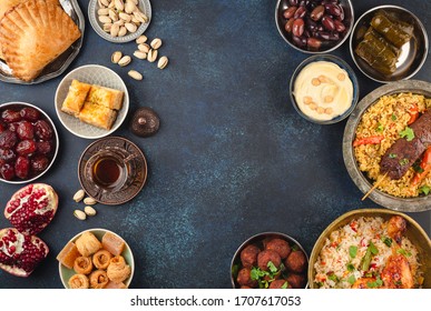 Ramadan Kareem Iftar Party Table With Assorted Festive Traditional Arab Dishes, Sweets, Dates. Eid Al-Fitr Mubarak Evening Grand Meal, Top View. Islamic Holidays Food, Ramadan Feast, Space For Text
