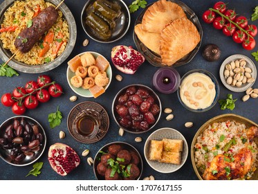 Ramadan kareem Iftar party table with assorted festive traditional Arab dishes, sweets, dates. Eid al-Fitr mubarak evening grand meal, top view. Islamic holidays food concept, Ramadan feast 