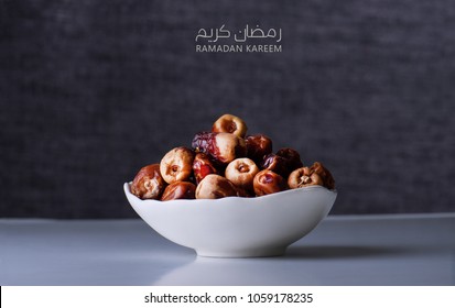 Ramadan kareem meaning Blessed ramadan with dates fruit in a bowl