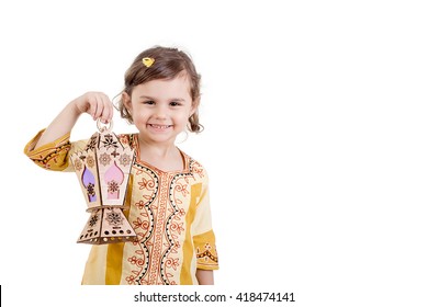 Ramadan Kareem - Young girl smiling and holding Ramadan lantern - Powered by Shutterstock