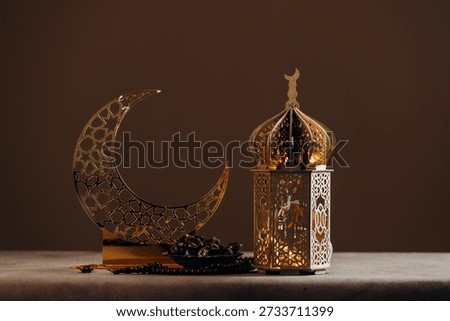 Ramadan  lamp, a string of prayer beads (tasbih) and a bowl of dates  for Muslim holidays. 