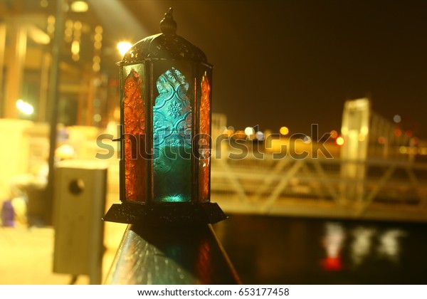 ramadan lantern with bridge and water\
reflection blur\
background