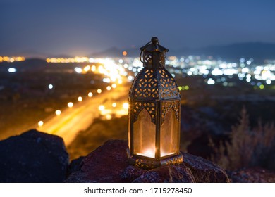 Ramadan Lantern Kept On Top Of The Hill With A Background Of The Valley In Which The City Is Illuminated.