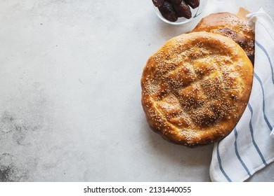 Ramadan Pide - Turkish popular bread for Ramadan month on a gray background. Copy space and top view.