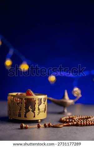 Ramadan themed image with dates, half moon and lamps.
