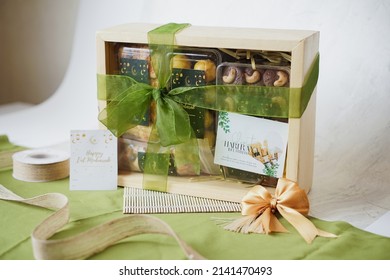 Ramadhan Hampers moslem theme for celebrate the holy, bake snack, nastar, bakery, cookies, pudding, choco chips, roll cake, castangel.with greeting card and green accessories on white background - Shutterstock ID 2141470493