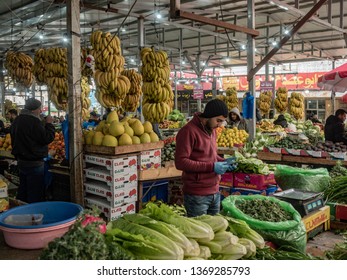 Ramallah, Palestine / Israel, 29 December 2018. Vendor at his stall at main ramallah market selling fruit, vegetables and produce
