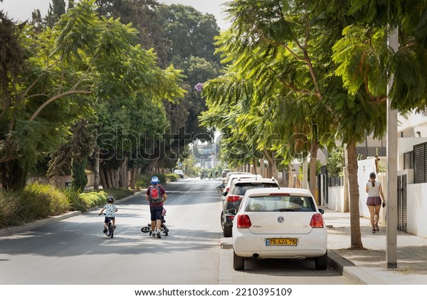 Ramat Gan, Israel -\
October 5, 2022: people are walking and riding bikes on the road on\
Yom Kippur holiday.