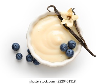 Ramekin of delicious vanilla pudding with blueberry on white background