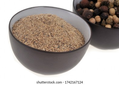 Ramekin Of White Pepper And Ramekin Of Peppercorns Close-up On A White Background