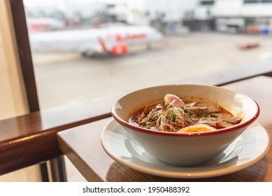 Ramen A Famous Japanese Food Noodle In Hot Soup With Airplane View At Airport Lounge Ramen Restaurant.