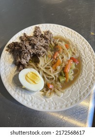 Ramen Noodle Vegetable Bulgogi Meat Hard Boiled Egg Bowl With Broth In White Bowl