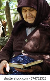 RAMETI, ROMANIA - JUNE 6, 2010: Elder Woman Reading The Bible. The Older Generations In The Rural Areas Of Romania Are Very Religious