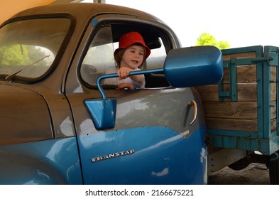 Ramla. Israel. June 2022. Truck and transport museum. A little boy is driving a vintage Studebaker. Blue retro truck Studebaker transtar. 