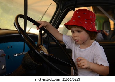 Ramla. Israel. June 2022. Truck and transport museum. A little boy is driving a vintage Studebaker. Blue retro truck Studebaker transtar. 