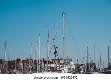 Ramsgate, Kent | UK -  2021.05.29: Male Working Up The Mast Of A Sailing Yacht At Yacht Marina In Ramsgate