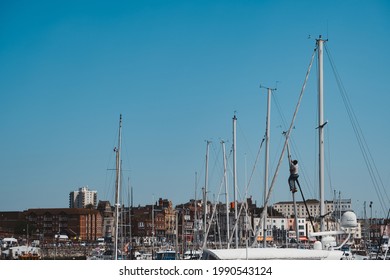 Ramsgate, Kent | UK -  2021.05.29: Male Working Up The Mast Of A Sailing Yacht At Yacht Marina In Ramsgate