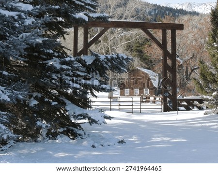 A ranch with a snow-covered barn