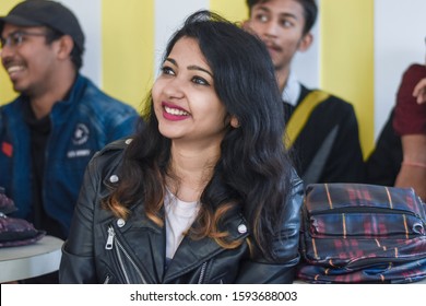 Ranchi, Jharkhand / India - December 15 2019 :  Cute Indian Girl In Audience. Young Beautiful Woman With Friends Watching Performance And Laughing. Group Of Cheerful People In An Open Mic Program. 