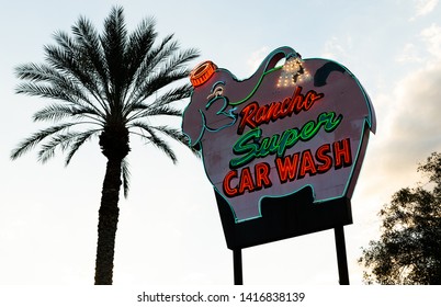 Rancho Mirage, CA / USA - March 18, 2019: Vintage Rancho Elephant Super Car Wash Sign With Palm Tree Coachella Valley At Dusk