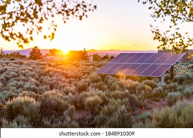Ranchos de Taos valley green landscape in summer and solar panels during sunset with sun rays in New Mexico