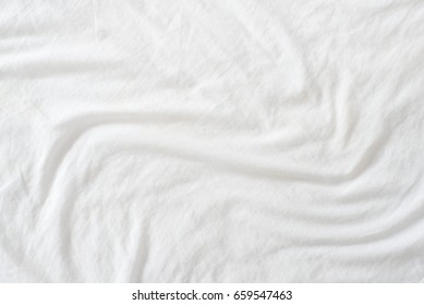 Random Abstract Pattern Of A White Crumpled Bed Sheet In A Hotel Room. The Manufacturing Of Bedsheet Uses Cotton, Cotton Blends, Polyester And Others Fibers Such As Linen, Silk Modal And Bamboo Rayon.