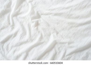 Random Abstract Pattern Of A White Crumpled Bed Sheet In A Hotel Room. The Manufacturing Of Bedsheet Uses Cotton, Cotton Blends, Polyester And Others Fibers Such As Linen, Silk Modal And Bamboo Rayon.