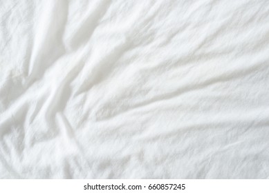 Random Abstract Pattern Of A White Crumpled Bed Sheet In A Hotel Room. The Manufacturing Of Bedsheet Uses Cotton, Cotton Blends, Polyester And Others Fibers Such As Linen, Silk Modal And Bamboo Rayon.